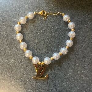 Elegant Gold and White Pearl Bracelet with LV charm